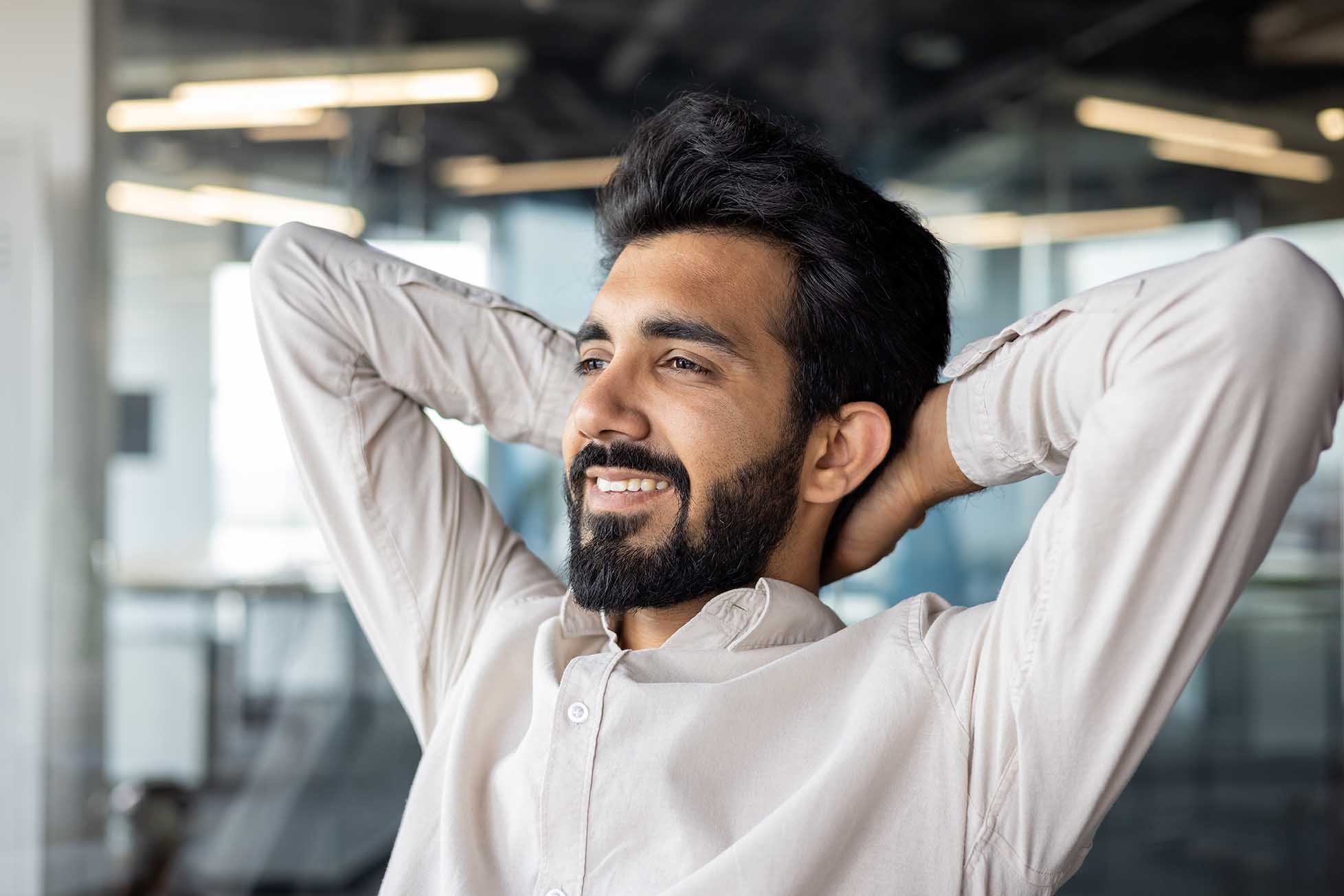 An image of a young professional looking happy and fulfilled